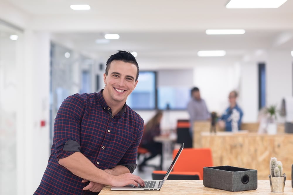 portrait of young businessman in casual clothes at modern  startup business office space,  working on laptop  computer